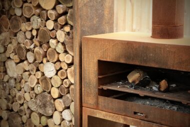 Corten outside fireplace with logstore in cotswold garden