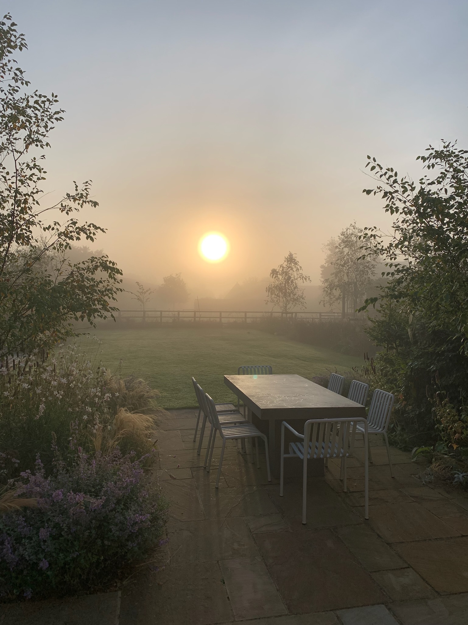 Misty sunrise morning over Cotswold garden by Hendy Curzon