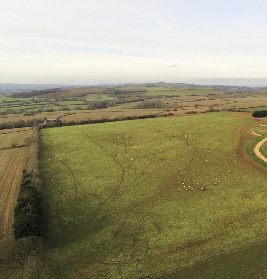 Ariel footage of farm land filled with sheep in Sibford Gower