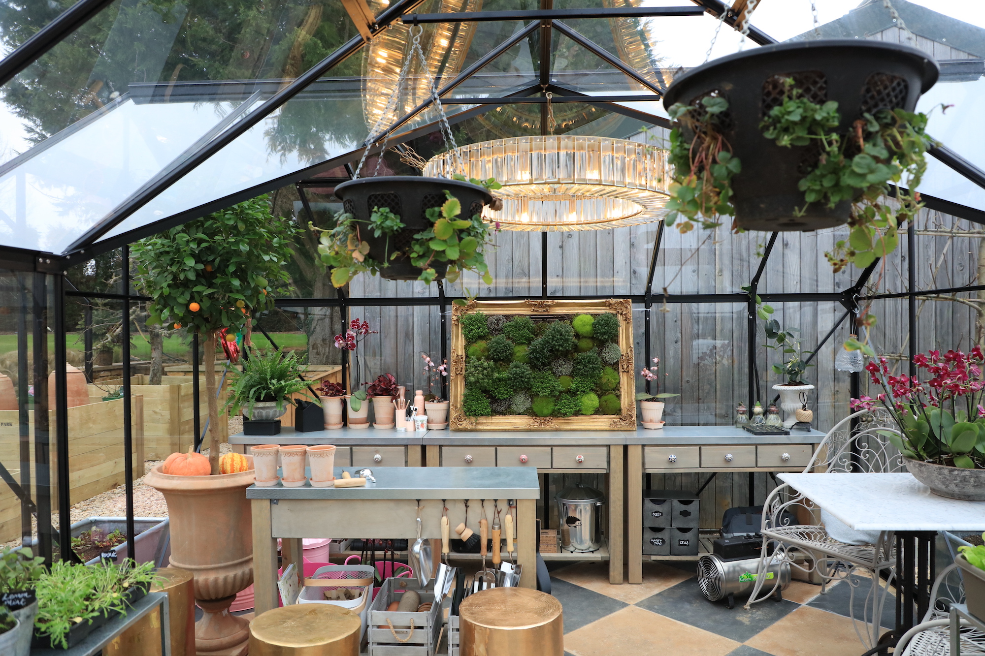 Inside productive glasshouse with living picture and gold chandelier 